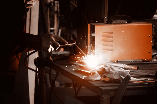 man-welding-old-shovel-close-up_127675-2552